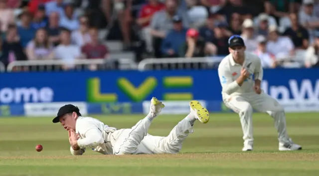 Michael Bracewell lying on the floor after dropping a catch