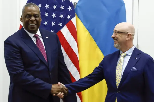 Lloyd Austin shakes hands with Ukraine"s Defence Minister Oleksii Reznikov before a Nato meeting in Brussels