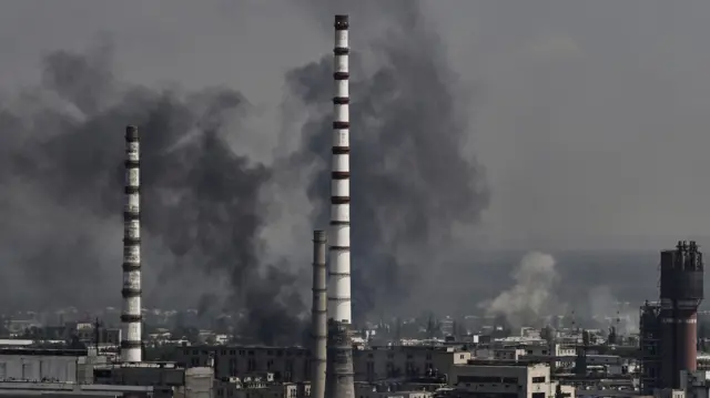 Smoke and dirt rise from the city of Severodonetsk