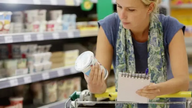 woman checks prices while shopping