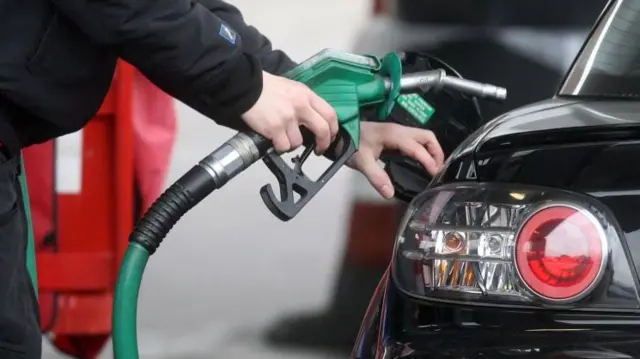 Person filling up car fuel tank (file image)