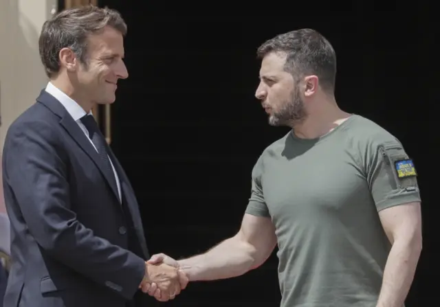 President Volodymyr Zelensky shakes hands with French President Emmanuel Macron