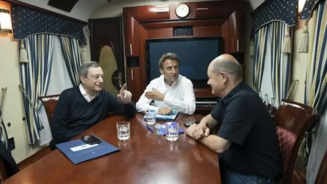 Italian Prime Minister Mario Draghi, French President Emmanuel Macron and German Chancellor Olaf Scholz talking inside a train carriage at an undisclosed location on their way from Poland to Kyiv, Ukraine, 16 June 2022.