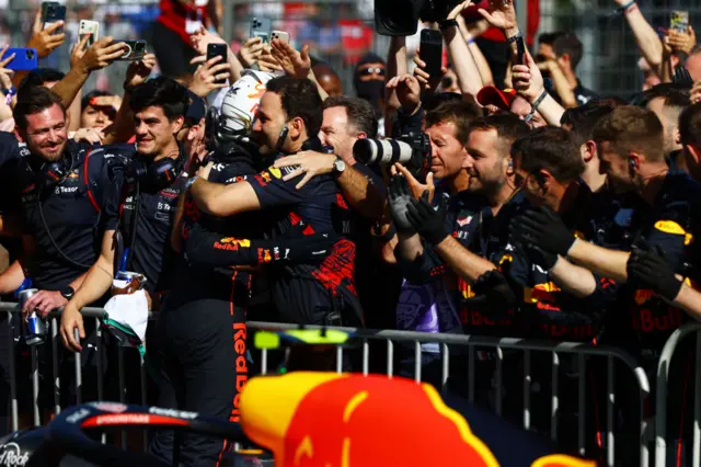 Max Verstappen hugs his Red Bull team after winning in Baku