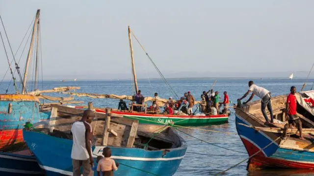 And fishermen chat on their boats in Pemba, northern Mozambique, on Thursday 16 June 2022