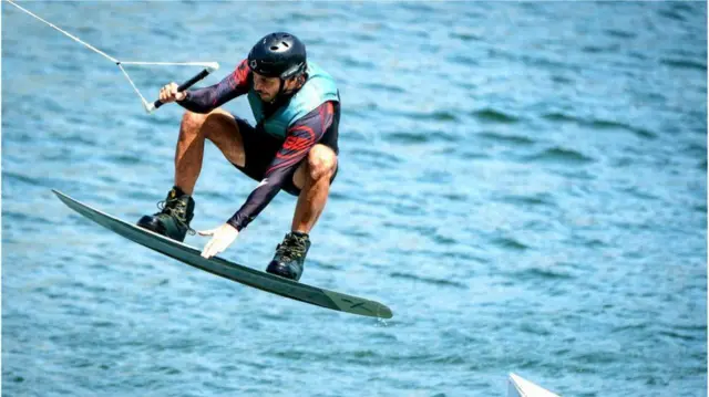 A hydrofoil rider takes off at Royal Docks in east London