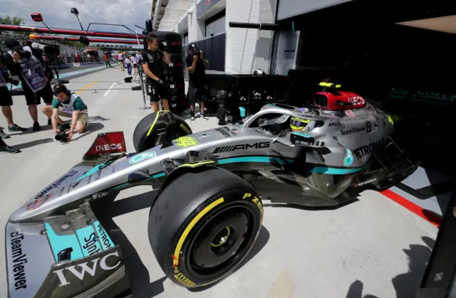 Lewis Hamilton exits the Mercedes garage in the car