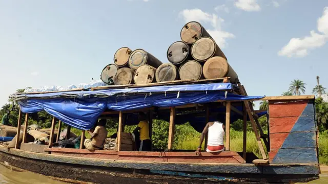 roducts of illegal oil refineries stuck in jerry cans are ferried to the market in Bayelsa State of Niger Delta - archive