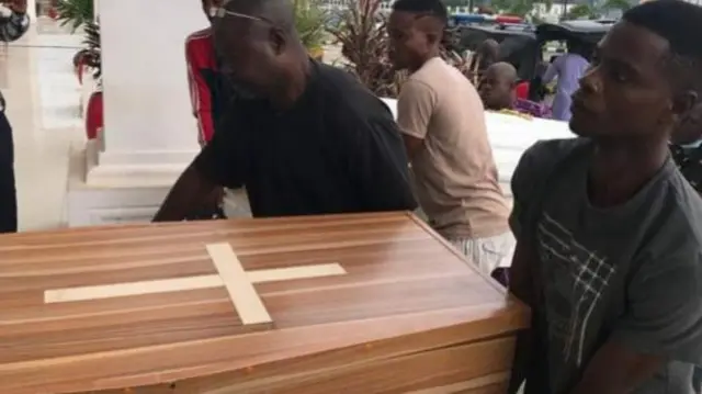 People carrying a coffin in Owo, Nigeria