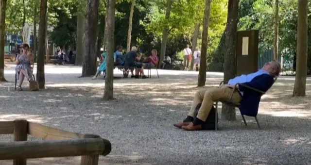 People try to stay cool in a public park in France