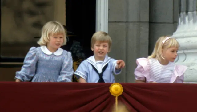 Prince William, Zara Phillips, and Lady Davina Windsor stand on the balcony of Buckingham Palace during Trooping the Colour on June 15, 1985.