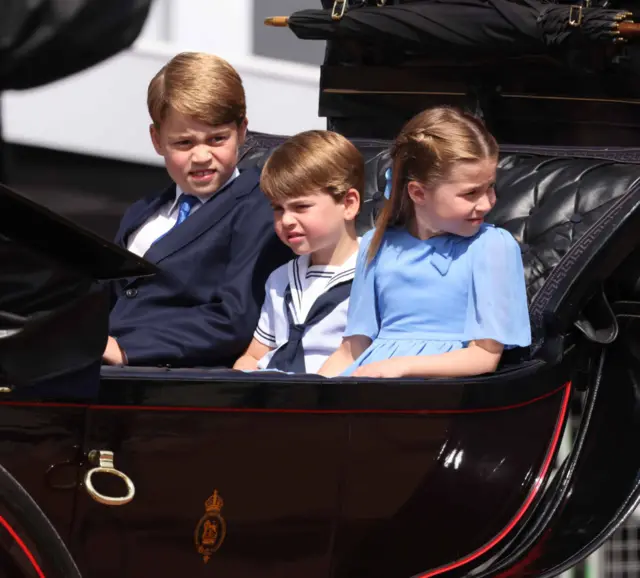 Prince George of Cambridge, Prince Louis of Cambridge and Princess Charlotte of Cambridge travel in a horse-drawn carriage during Trooping The Colour on June 2, 2022