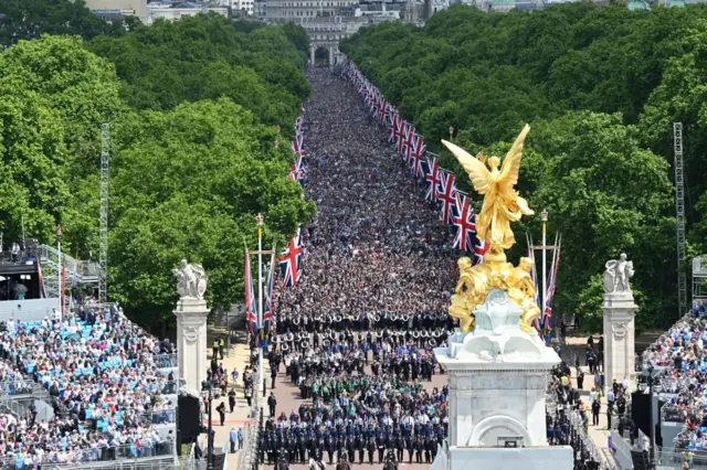 Members of the public fill The Mall ahead of a flypast over Buckingham Palace