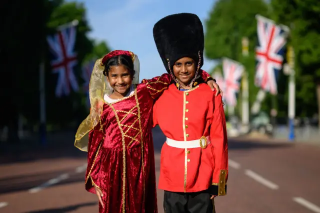 Royal fans Caellia (L) and Yoshilen wear costumes as they arrive on the Mall to celebrate the first day of celebrations to mark the Platinum Jubilee of Queen Elizabeth II