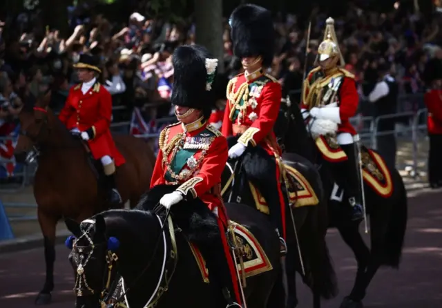 Britain"s Prince Charles and Prince William ride on horseback during the Trooping the Colour parade