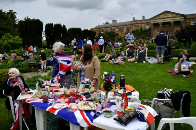 People enjoy a garden party during the Britain"s Queen Elizabeth II"s Platinum Jubilee celebrations, at Hillsborough Castle, in Royal Hillsborough, Northern Ireland June 2, 2022