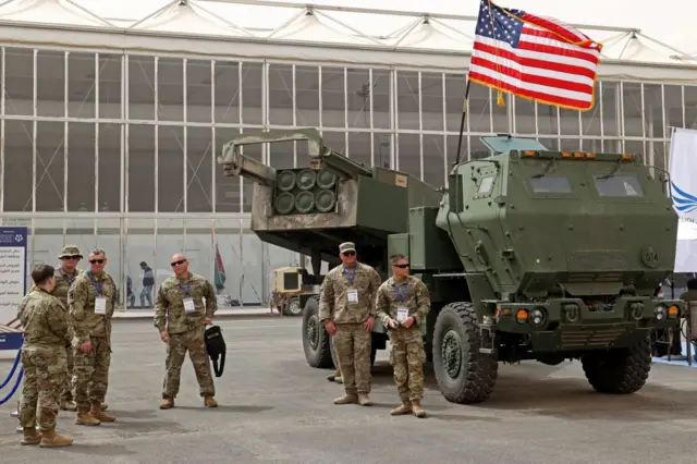 US military personnel stand by a M142 HIMARS during Saudi Arabia's first World Defense Show