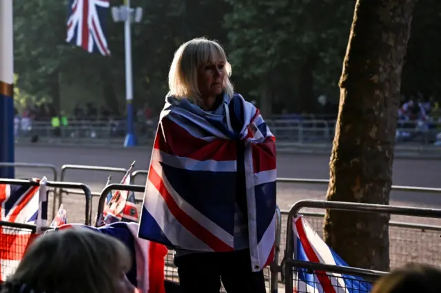 A woman wrapped in the Union Flag on the Mall on Thursday morning