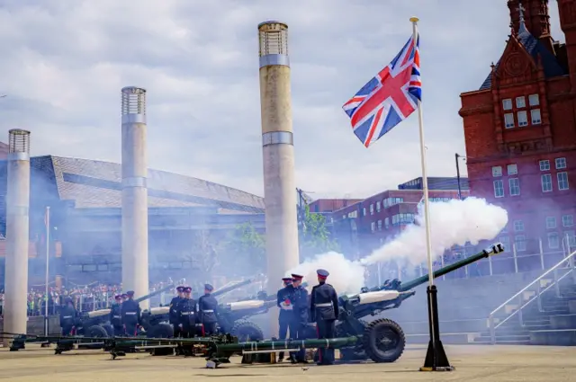 The Union flag flutters during the salute in Cardiff"s Roald Dahl Plass