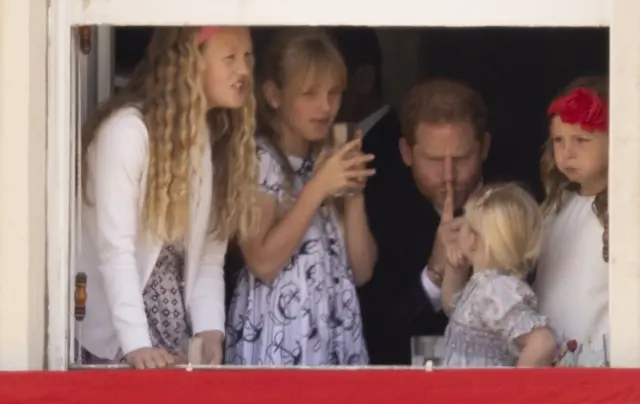 Prince Harry with Savannah Phillips and Mia Tindall overlooking the Trooping the Colour