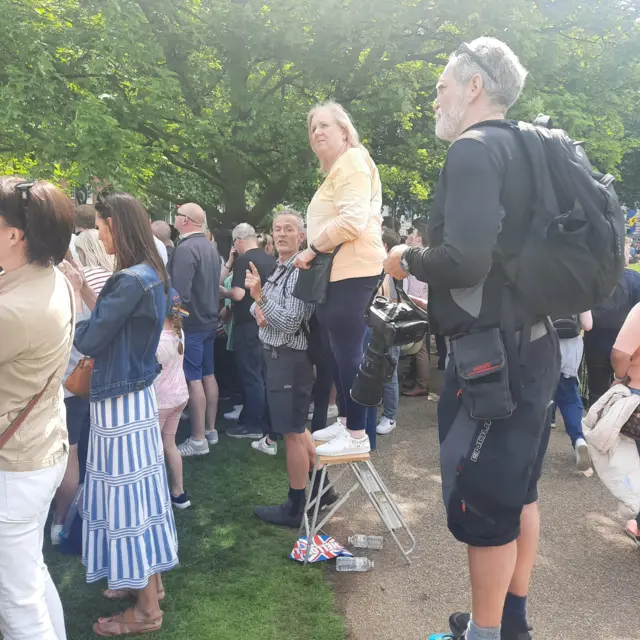 Member of the public Sharon stands on a stepladder to see the Trooping the Colour