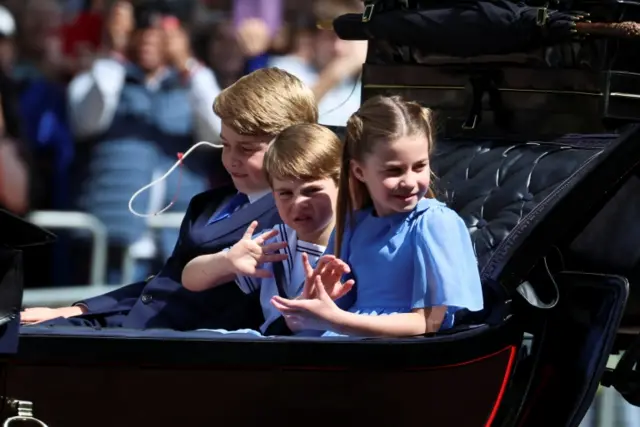 Britain"s Princess Charlotte, Prince George and Prince Louis ride in a carriage during the Trooping the Colour parade