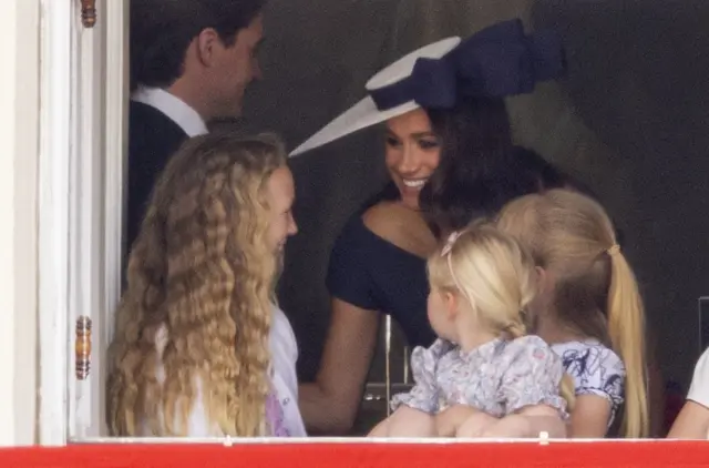 Meghan, Duchess of Sussex, with Savannah Phillips and Mia Tindall overlooking the Trooping the Colour