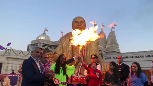 A beacon is lit in front of a statue at the Neasden Hindu Temple in London