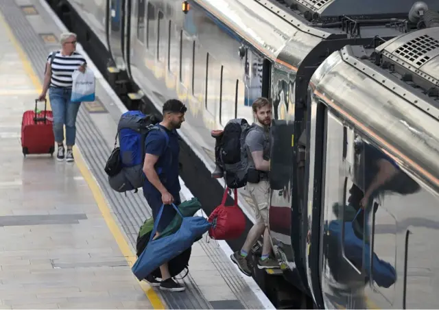 Passengers travel ahead of a rail strike