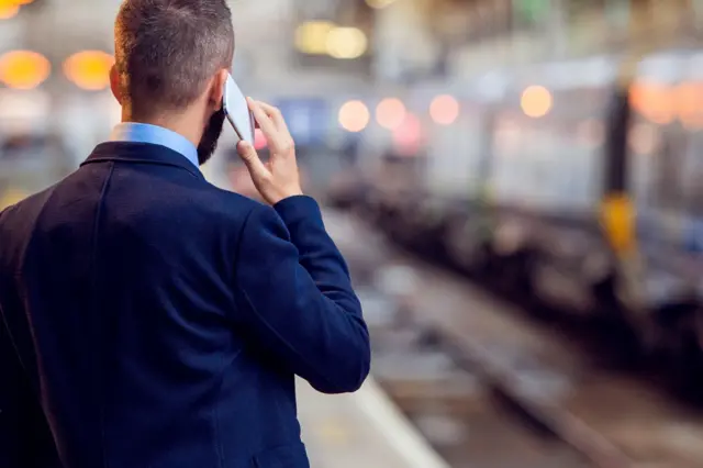 A commuter talks on a mobile phone