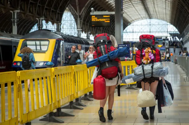 Festival goers prepare to board trains at Paddington station to travel to Castle Cary station for the first day of the 2014 Glastonbury Festival