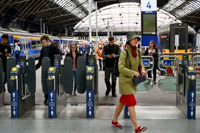 Members of the public pass through Queen Street station in Glasgow