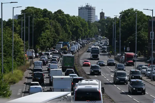 Cars queue in traffic in Hammersmith as commuters make their way to central London