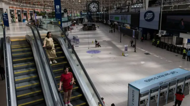 Commuters on an escalator in Waterloo station