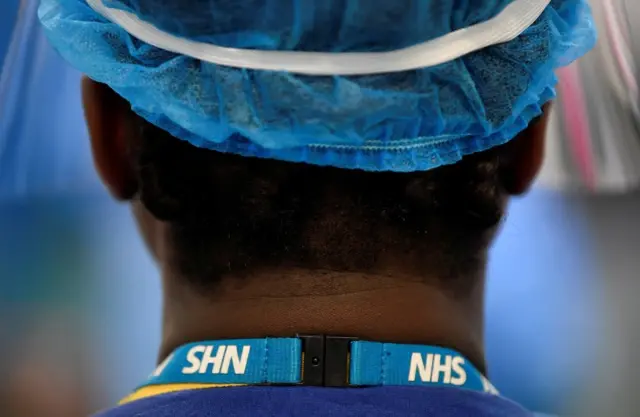 Generic shot of the back of an NHS worker