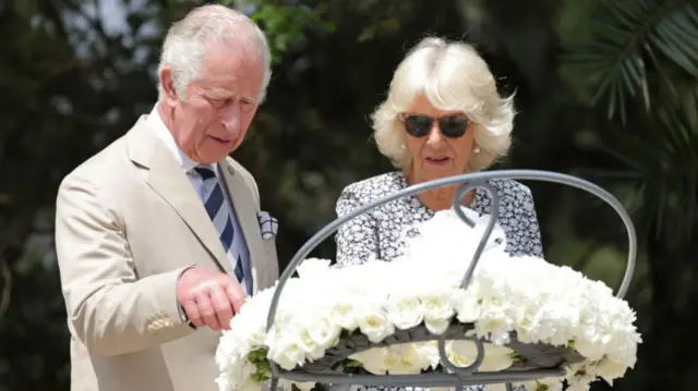 ritain's Prince Charles, Prince of Wales, and Britain's Camilla, Duchess of Cornwall pause in front of a flower wreath at the Kigali Genocide Memorial, Kigali, Rwanda on June 22, 2022 during a visit