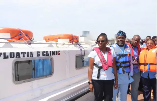 People standing next to the floating clinic