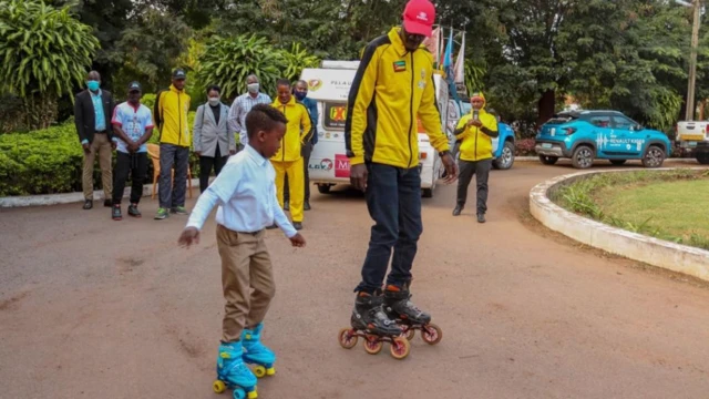 One of the roller-bladders teaching a child to roller skate