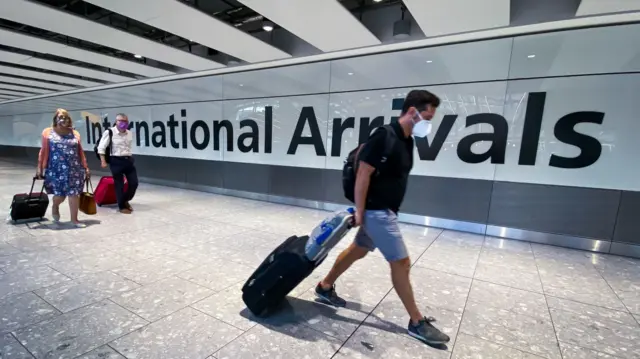 Passengers in the arrivals hall at Heathrow Airport, London