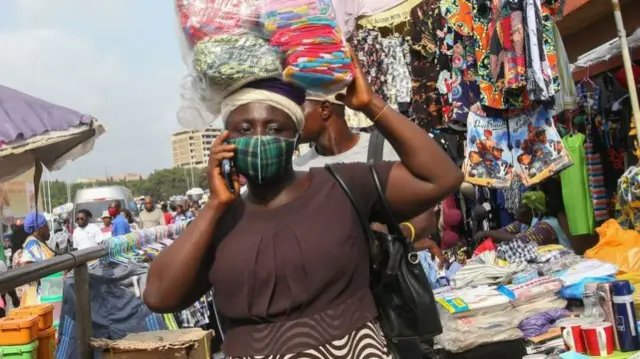 A woman wears a face mask in Accra