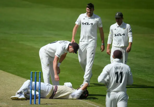 Craig Overton on the floor after being hit by a bouncer from brother Jamie