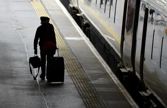 A passenger walks along a platform at Waverley Station in Edinburgh on the second day of train strikes