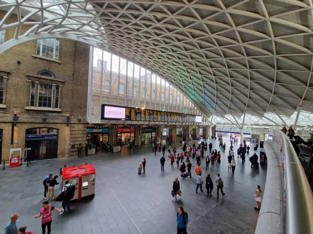 Far fewer people than usual in front of the King's Cross departures and arrivals board