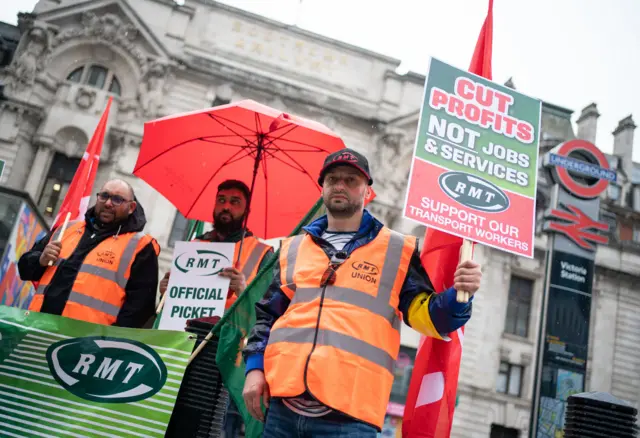 Protesters on a picket line outside Victoria station in London