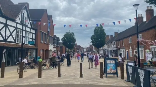 People walk down a street in Stratford-upon-Avon