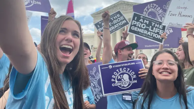 Anti-abortion activists celebrate outside the Supreme Court