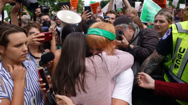 Image shows activists and congresswoman Alexandria Ocasio-Cortez outside Supreme Court