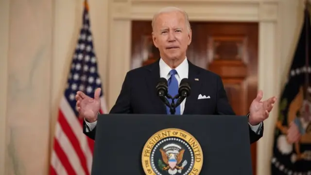 President Joe Biden speaking at a podium.