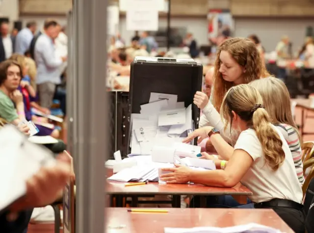 Staff count ballot papers after a by-election, at Thornes Park Athletics Stadium in Wakefield