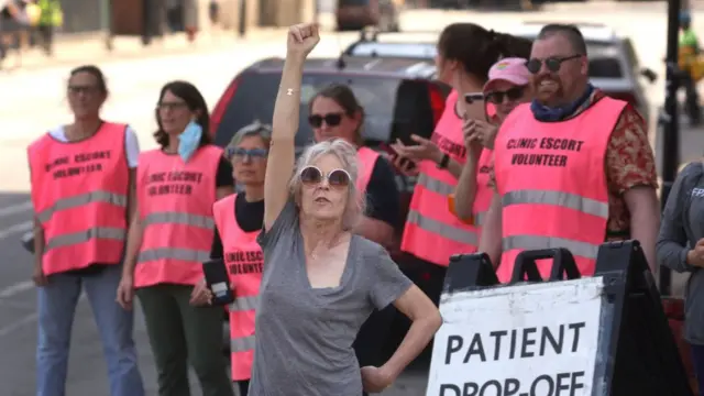 Abortion rights demonstrators stand outside a family planning clinic.